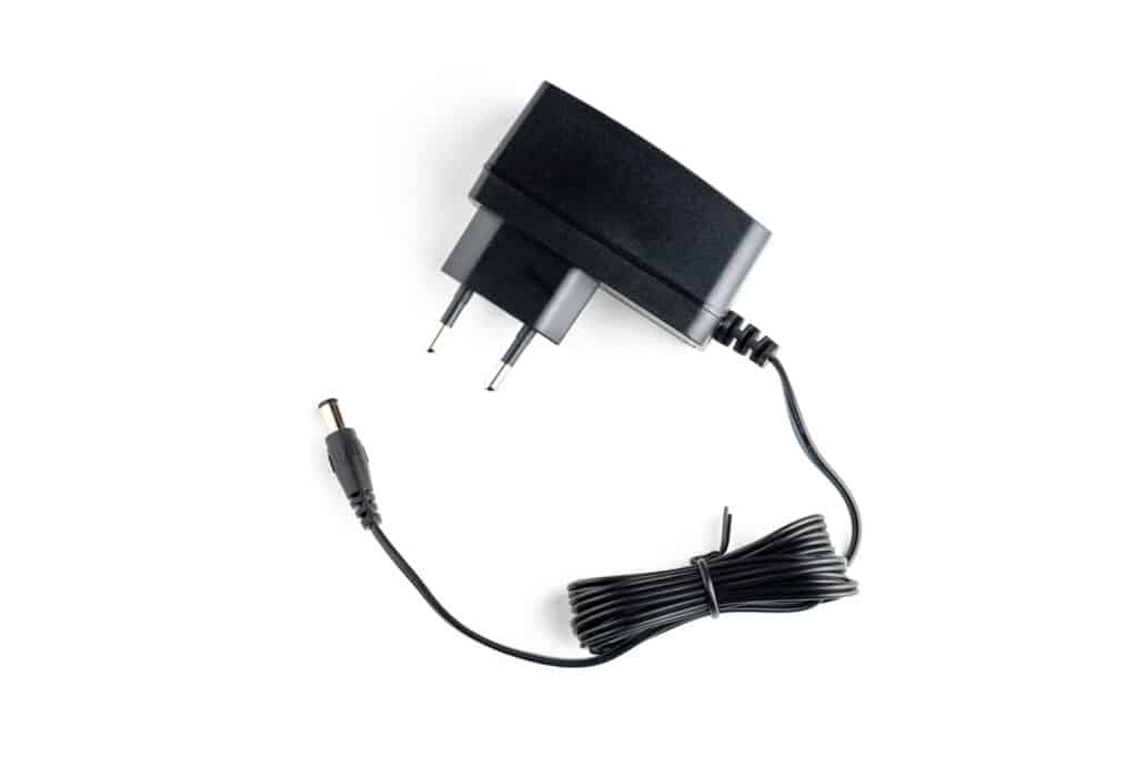 a ac dc black power adapter isolated on white background. view from above.
